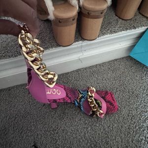 Pink heels with chains around the ankle, and in the front. Never been worn.